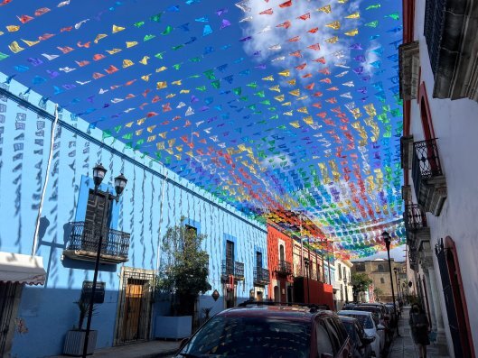 A Oaxacan street with flags overhead