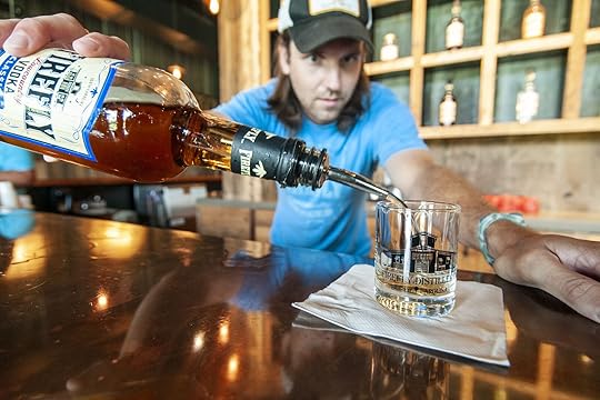 Bartender Adam Graudin pours a sample in the Tasting Room at Firefly Distillery in North Charleston, South Carolina