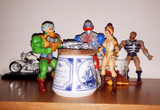 Duncan, Roboto and Teela are gathered around a work table, while Fisto is standing in the background.