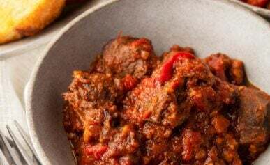 A bowl of caldereta made with a venison neck roast.