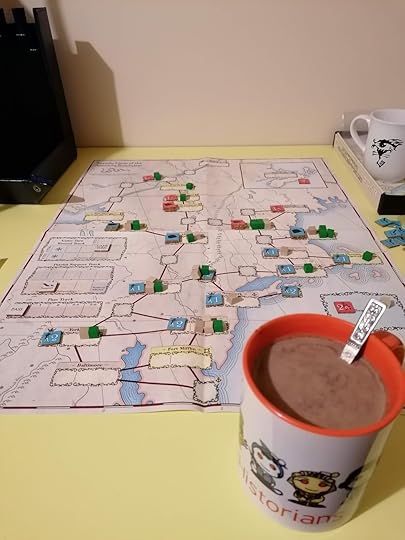 Image of the game map about midway through the game with a mug of hot chocolate near the front of the frame just off the map