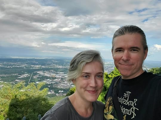 Andy Reynolds and Mallory Whitfield smiling with the city of Chattanooga, Tennesee far below them in the background. Taken from the top of Lookout Mountain.