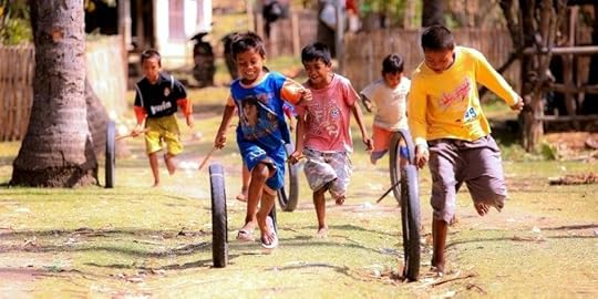 Kids playing with tyres and sticks