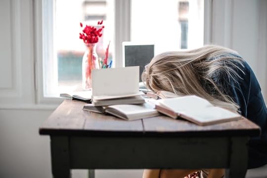 a girl resting on a desk