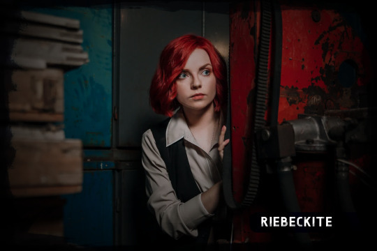 Red-haired woman in dark industrial room