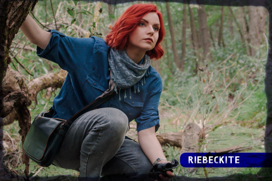 Red-haired woman in forest crouched on log
