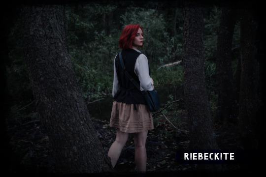 Red-haired standing in forest at night