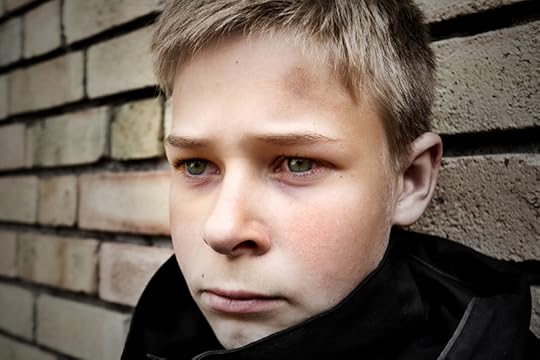 A boy looks off into the distance, looking hopeless. Feelings of shame can affect health.