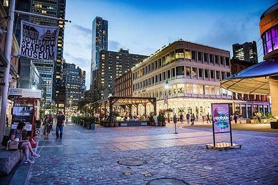 A cobblestone street in South Street Seaport at night, where Manhattan by Sail is located