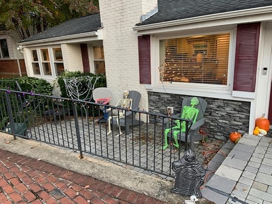 A pair of skeletons have a quiet conversation on the patio.