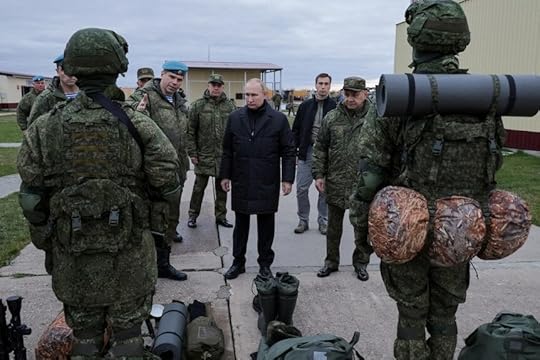Russian President Vladimir Putin listens to members of his military.