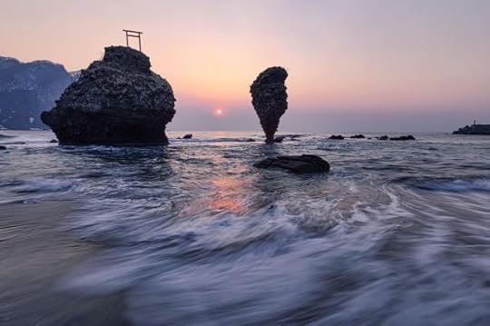 Cliffs in sea near coast at sunset by Sami Anas