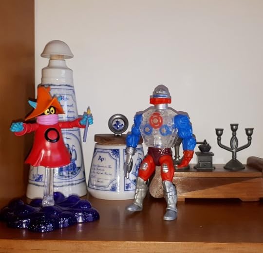 Orko is demonstrating a magic trick to Roboto.