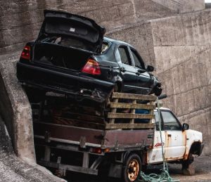 Broken truck carrying a car on the roof