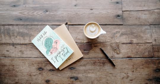 I Promise I Tried poetry book on brown wooden table with latte, pen, and notebook