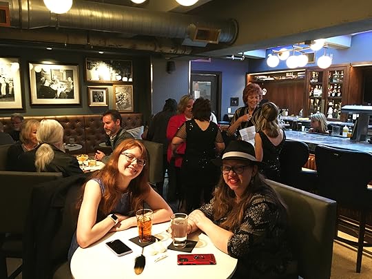 Inside a remodeled hidden speakeasy in a 1927 hotel during a bookish 1920's party.