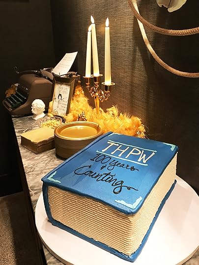 Bookish decorations to use for a literary themed party such as a typewriter, a writer's bust, a candelabra and book cakes.