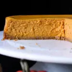 cheesecake on cake platter, with a fourth cut away.