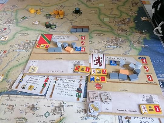Two Christian lord mats with all their counters and cards sitting on top of the game map near Toledo