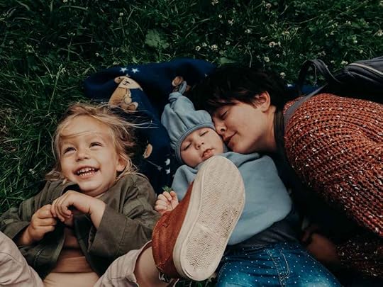 affectionate mother lying beside her children