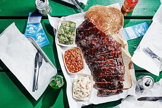 A platter of barbecue rubs with sides against a green background at Martin's Bar-B-Que Joint