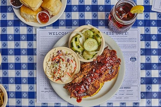 a platter of pulled pork, pickles, and coleslaw on a blue checked tablecloth at Loveless Cafe, where to go for the best bbq in Nashville