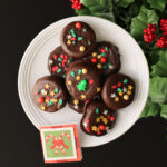 white plate of christmas themed chocolate dipped oreos.
