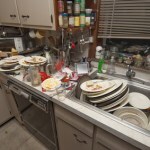 Dirty dishes piled up in sink after a party