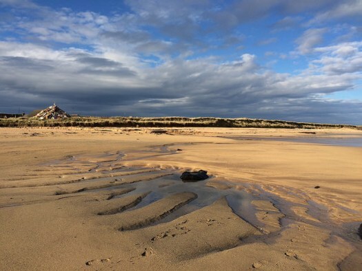 shadows and light at st combs beach in Aberdeenshire