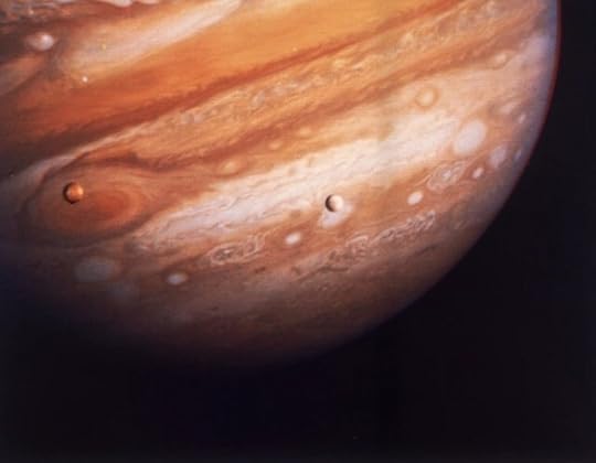 Jupiter and two of its moons, Io (left) and Europa (right), taken by the Voyager 1 spacecraft in 1979