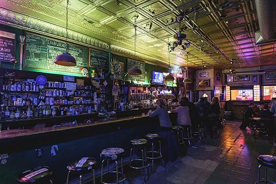 L&L dive bar Chicago interior with patrons at the bar and green lights 