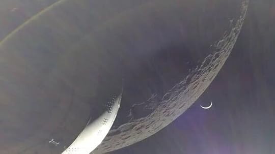 The Orion spacecraft, the moon and a distant crescent Earth are seen in this image from a camera on one of the craft���s solar panels. NASA photo