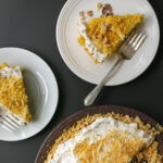 overhead shot of two plates of marshmallow pie next to the full pie.