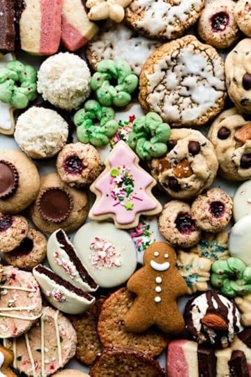 assortment of Christmas cookies including sugar cookies, gingerbread cookies, thumbprints, oatmeal cookies, coconut macaroons, and spritz cookies