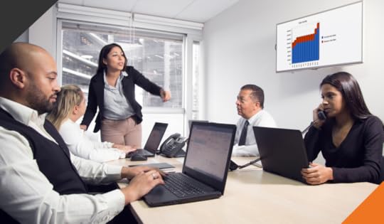 four employees seated at a meeting table discussing Three techniques for more effective meetings at work
