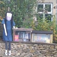 photo of Matilda scarecrow with Little Free Library