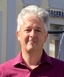 A picture of a middle-aged man with grey hair