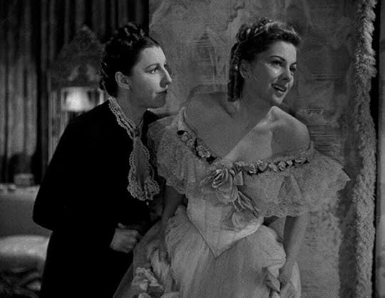 Mrs. Danvers sternly eyes a weeping Mrs. de Winters.