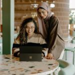 Two friends looking at a laptop screen