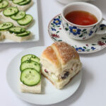 tea party table set with tea and sandwiches.