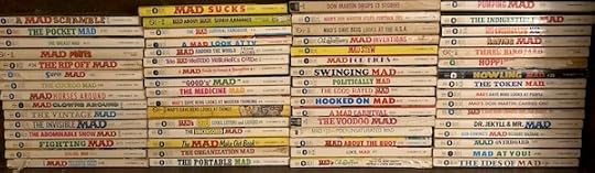 s shelf with MAD paperback books of various titles
