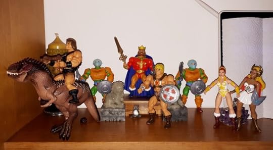 Wun-Dar rides off on Giga, while King Randor, He-Man, She-Ra, Teela and two guards look on.