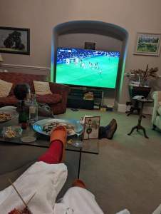 People in a sitting room watching telly