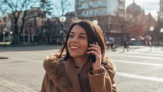 young professional woman talking on her phone in an empty city square