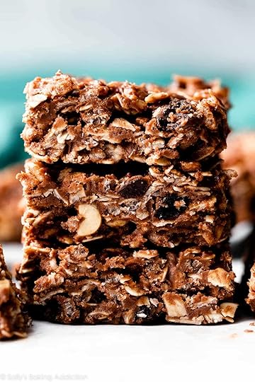 stack of 3 no-bake chocolate oat bars with blue linen in background.