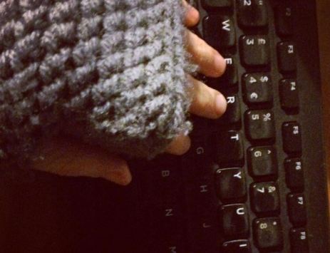 writing in fingerless gloves