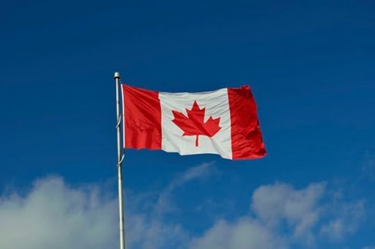 Canadian flag against blue sky