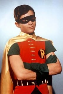 Robin as portrayed by Burt Ward in the 1960s Batman live action TV show. He's posed with his arms folded over his chest.
