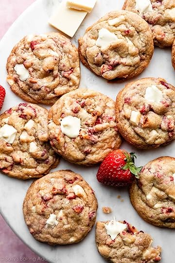 white chocolate strawberries & cream cookies on marble backdrop with fresh strawberry and white chocolate chunks.