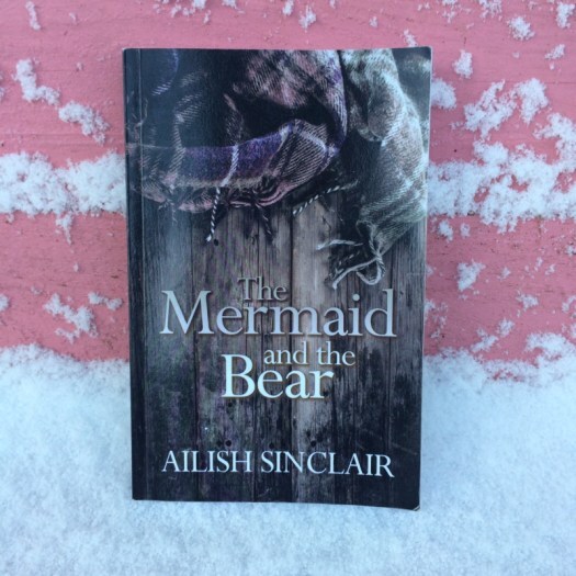 The Mermaid and the Bear on the pink bench in the snow